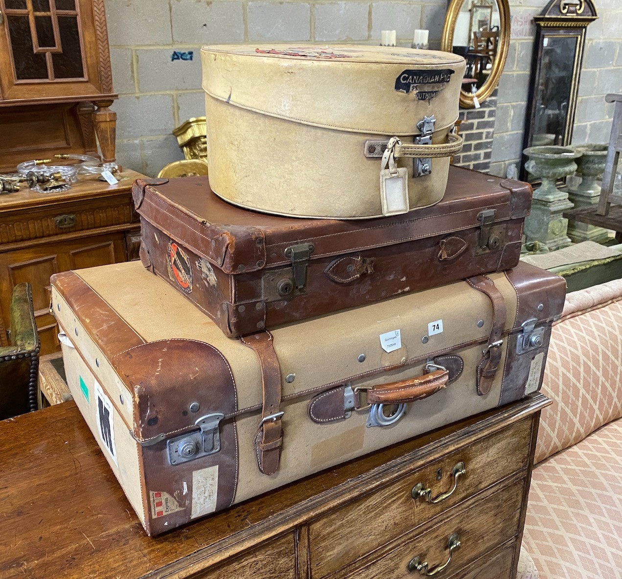 A leather and canvas covered suitcase, a small brown leather suitcase and hatbox, largest width 84cm, depth 50cm